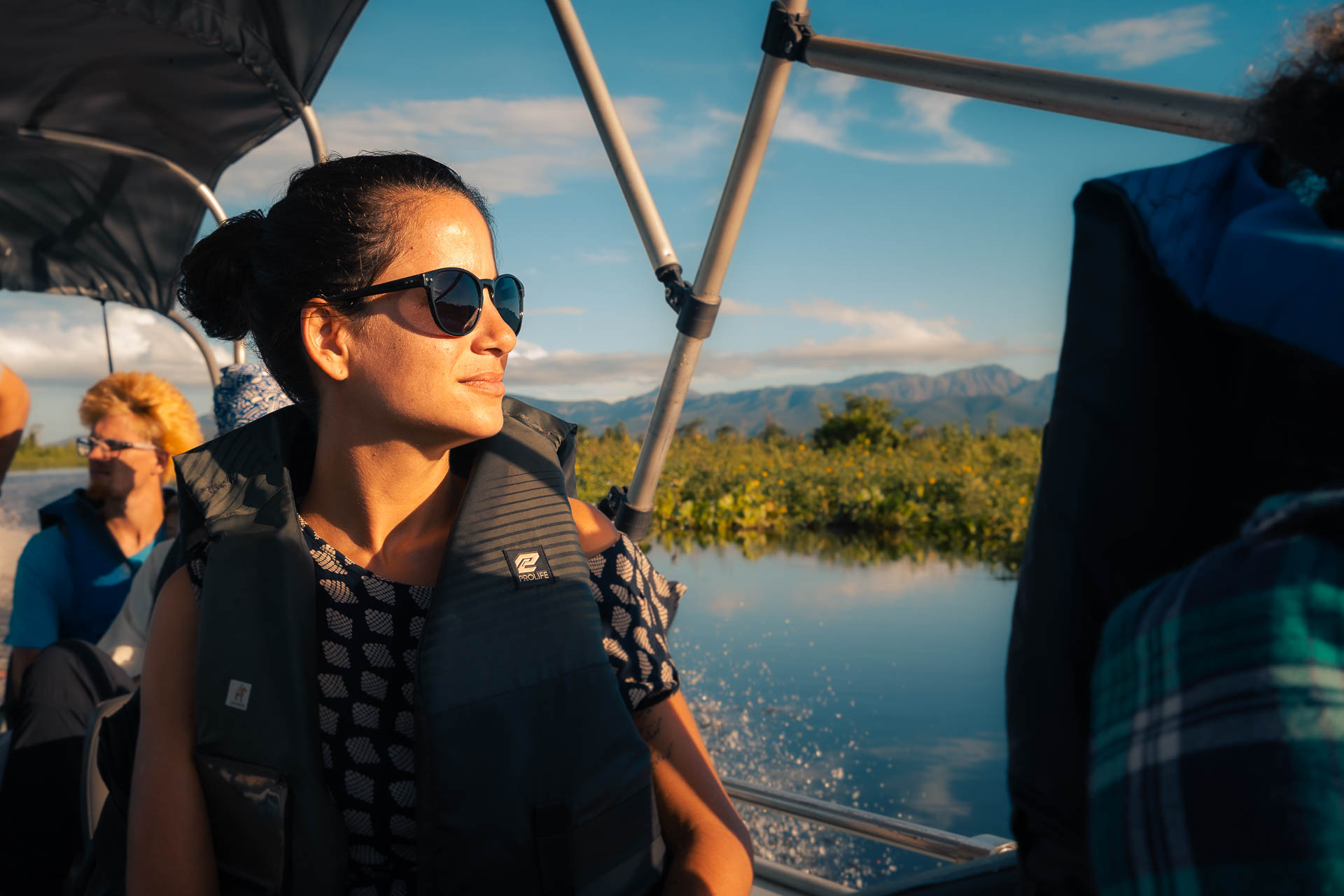 Fernanda with the sun on her face in a boat going to Serra do Amolar in Pantanal