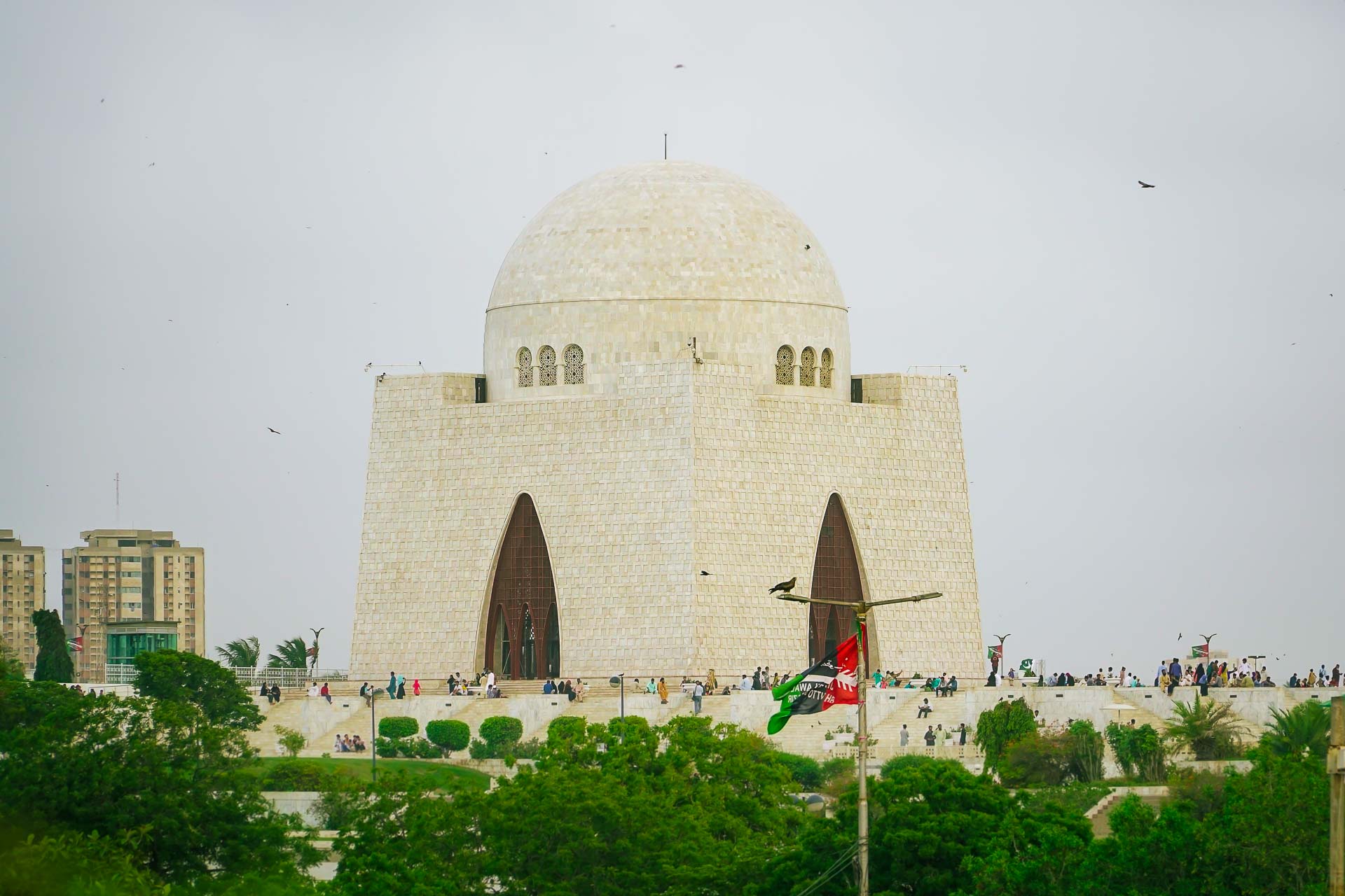 a large monument surrounded by people who seem really small near it