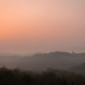 The sun setting in the horizon in a pinkish sky in Slovenia