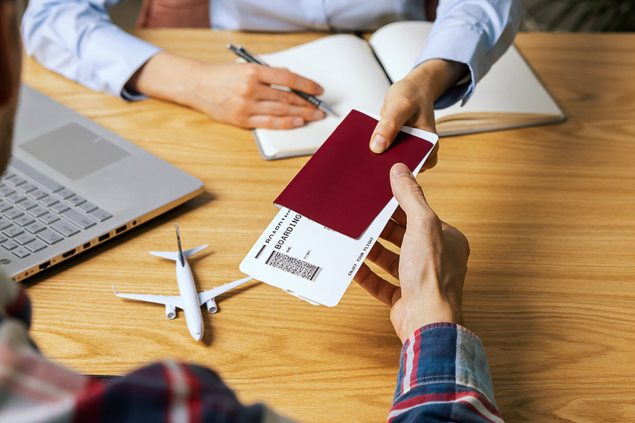 customer buying flight tickets in travel agency for his next trip