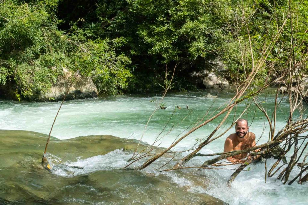 Tiago in the river posing for the photo