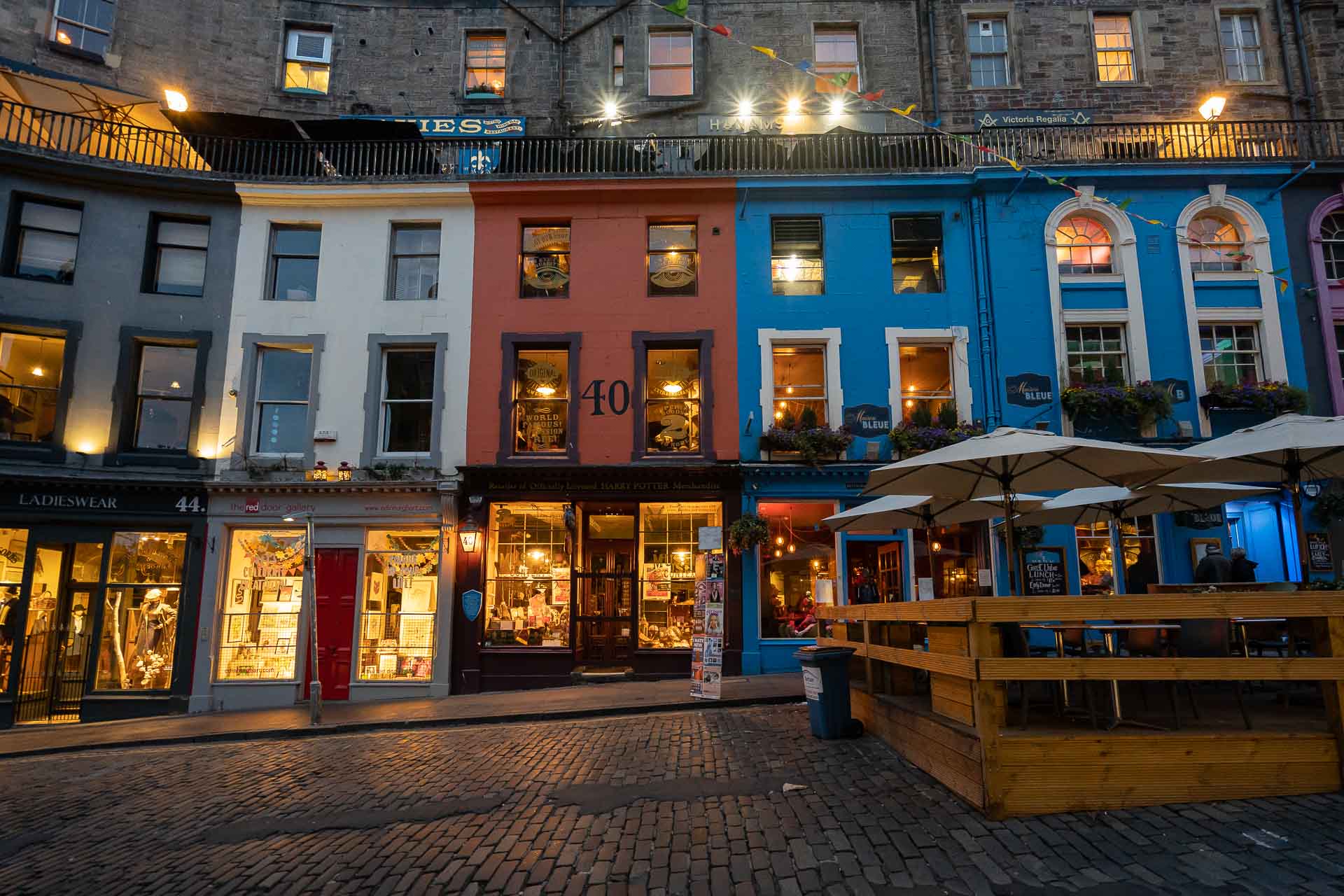 Colourful old houses on a cobbled street and yellow lights