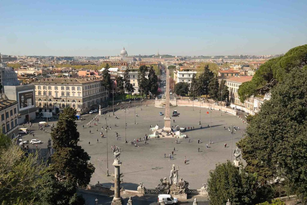 The Piazza del Popolo in Rome with a a large square space and a monument in the middle