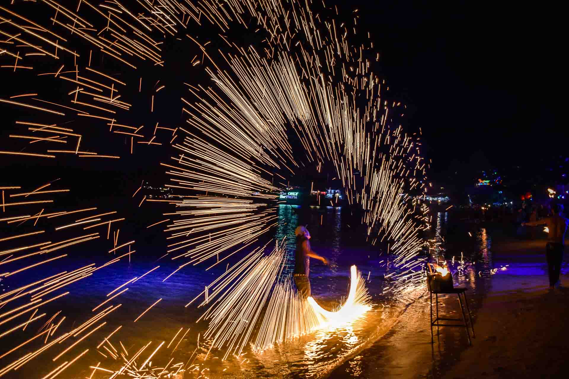 A Thai man doing a fire show in Thailand at the Full Moon Party