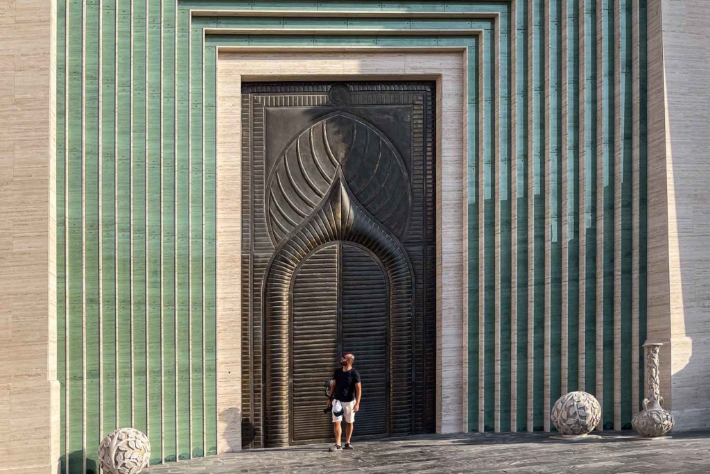 Tiago in front of a huge door in Doha