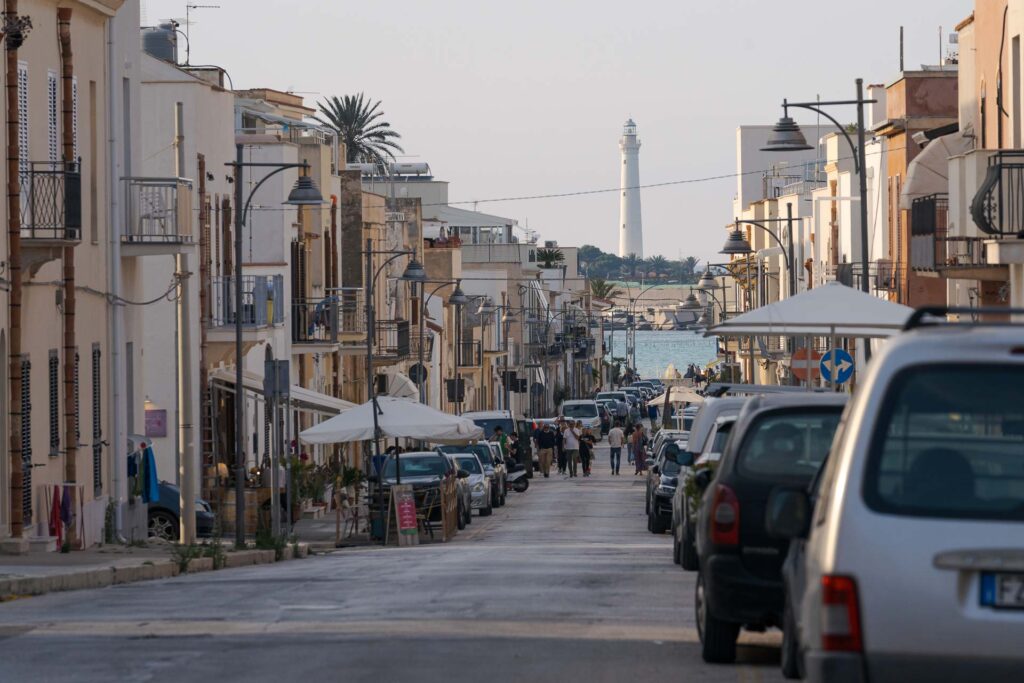 As ruas de São Vito Lo Capo na Sicília com o farol da ilha ao fundo