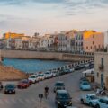 Colourful houses by the sea in the historical city centre of Syracuse in Sicily