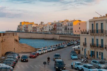 Colourful houses by the sea in the historical city centre of Syracuse in Sicily