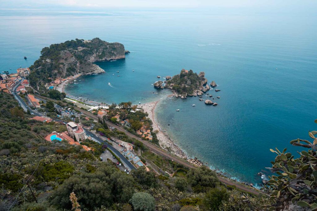 Overview of the beach of Taormina divided into two beaches with an island in the middle